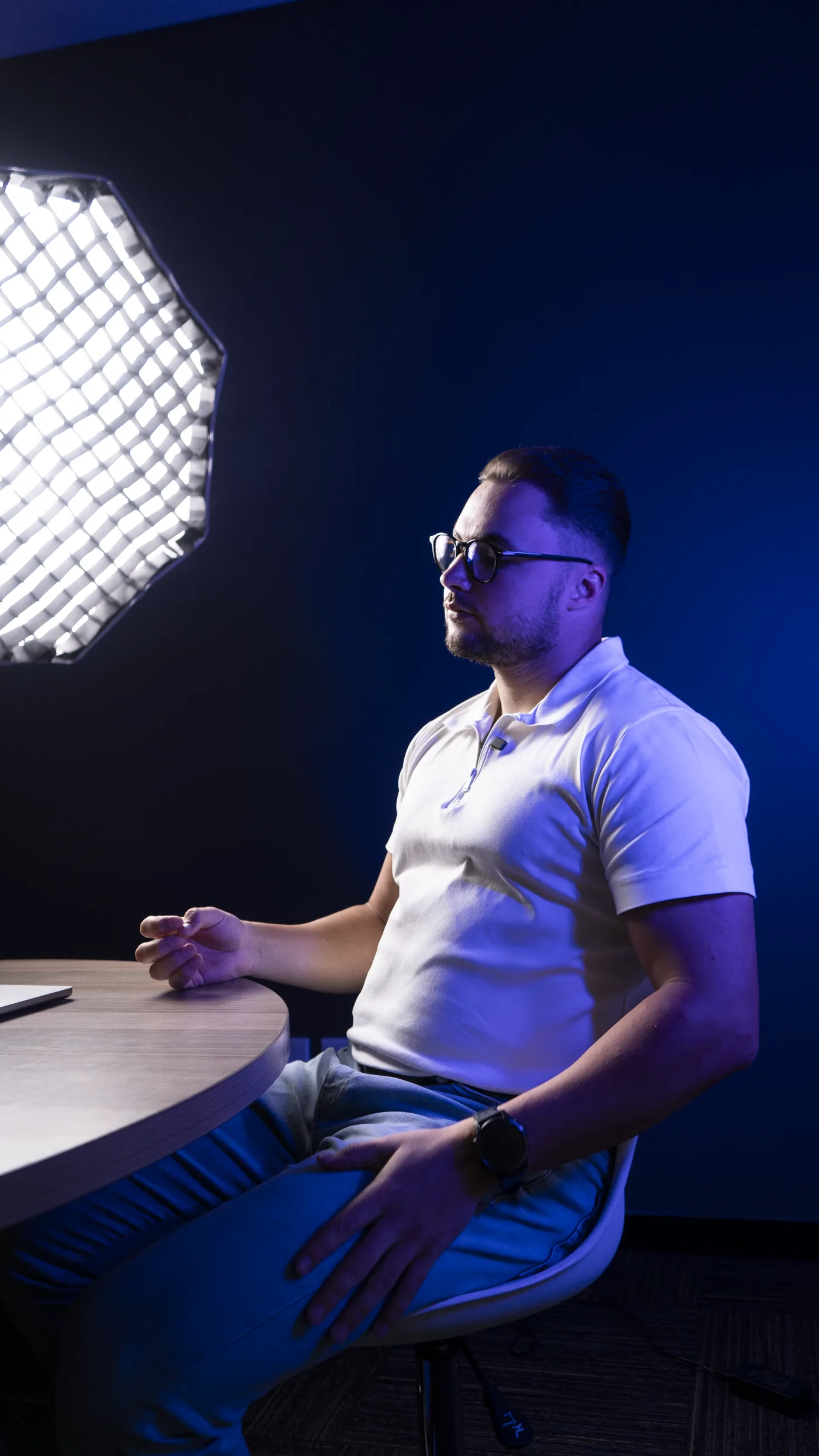 Joshua Joseph, founder of Cedar Digital, seated at a table in the studio